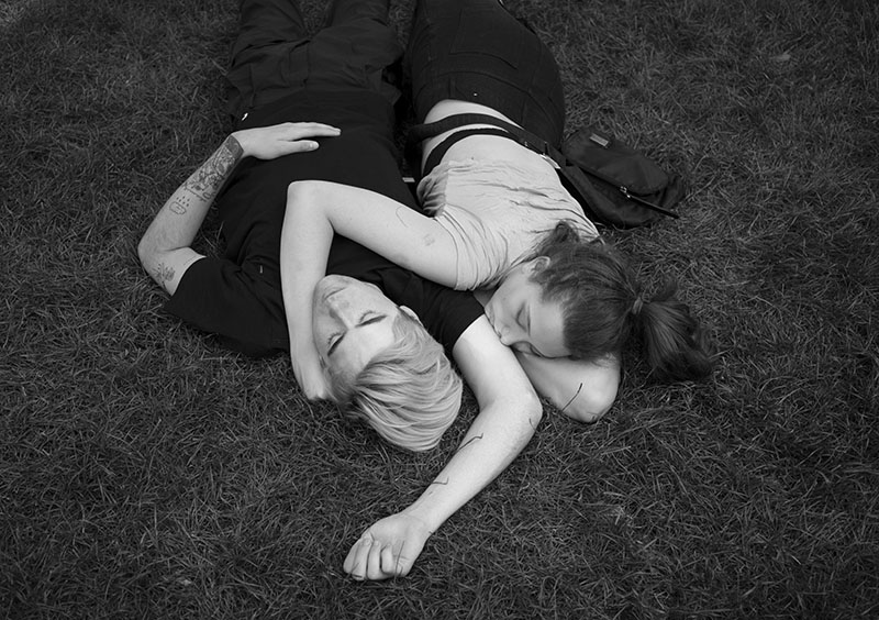 Male and Female Sleeping in a Park